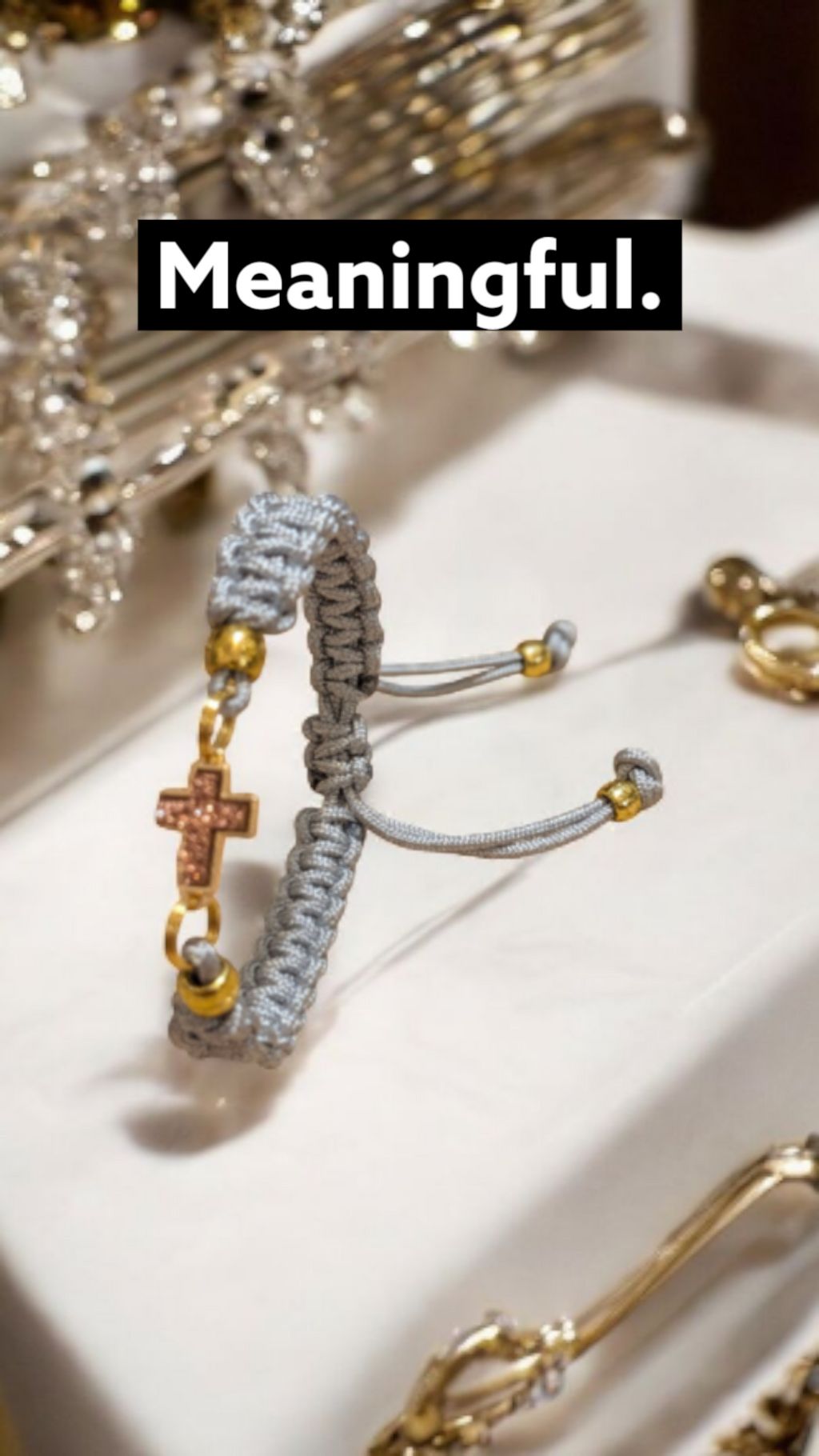 Adjustable Grey Paracord Bracelet with a Pink Champagne Cross Pendant.