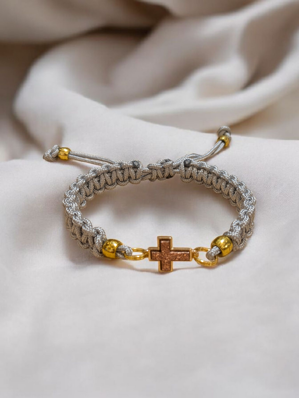 Adjustable Grey Paracord Bracelet with a Pink Champagne Cross Pendant.